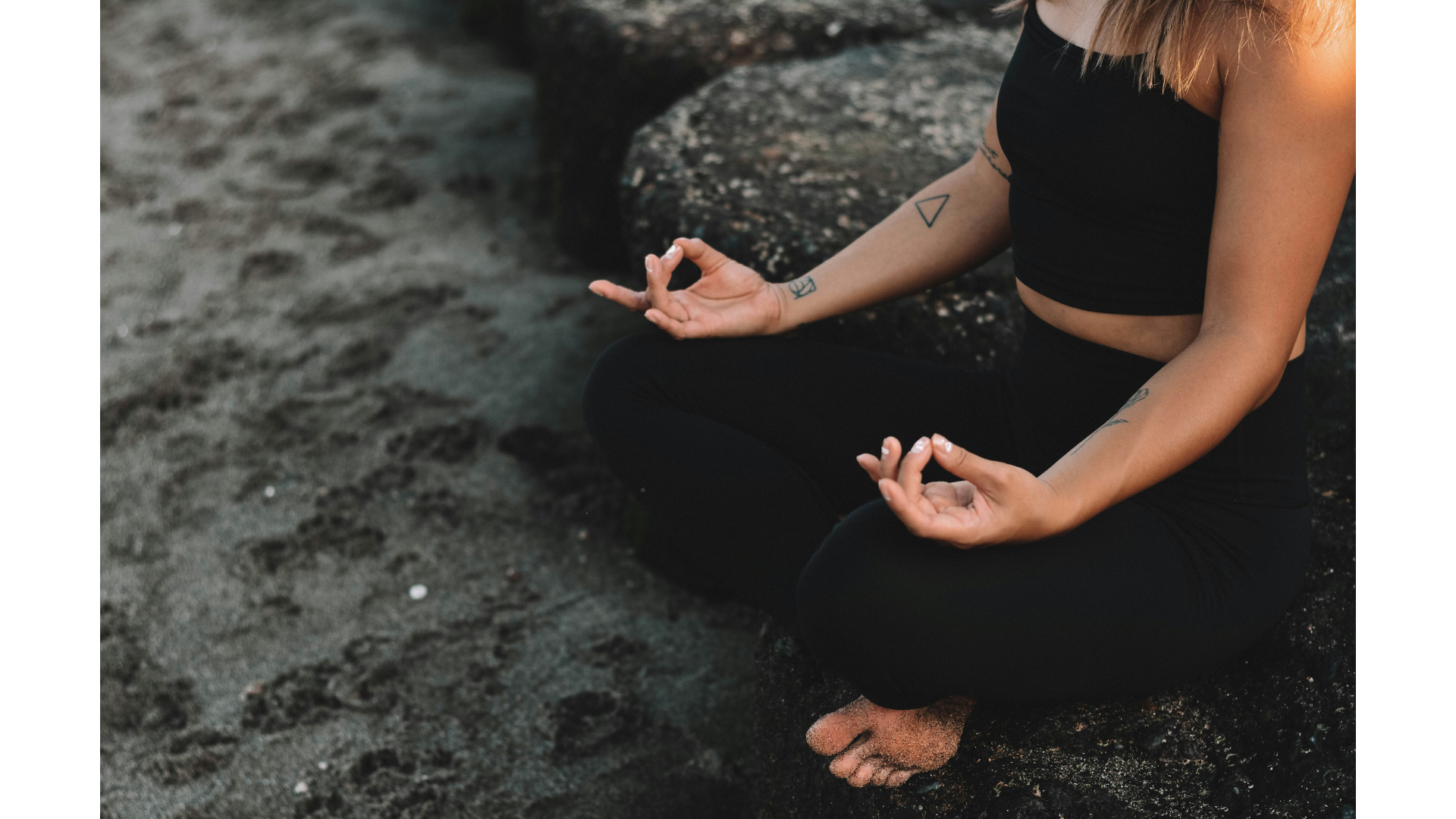 Woman sitting cross-legged meditating while contemplating eco-conscious yoga