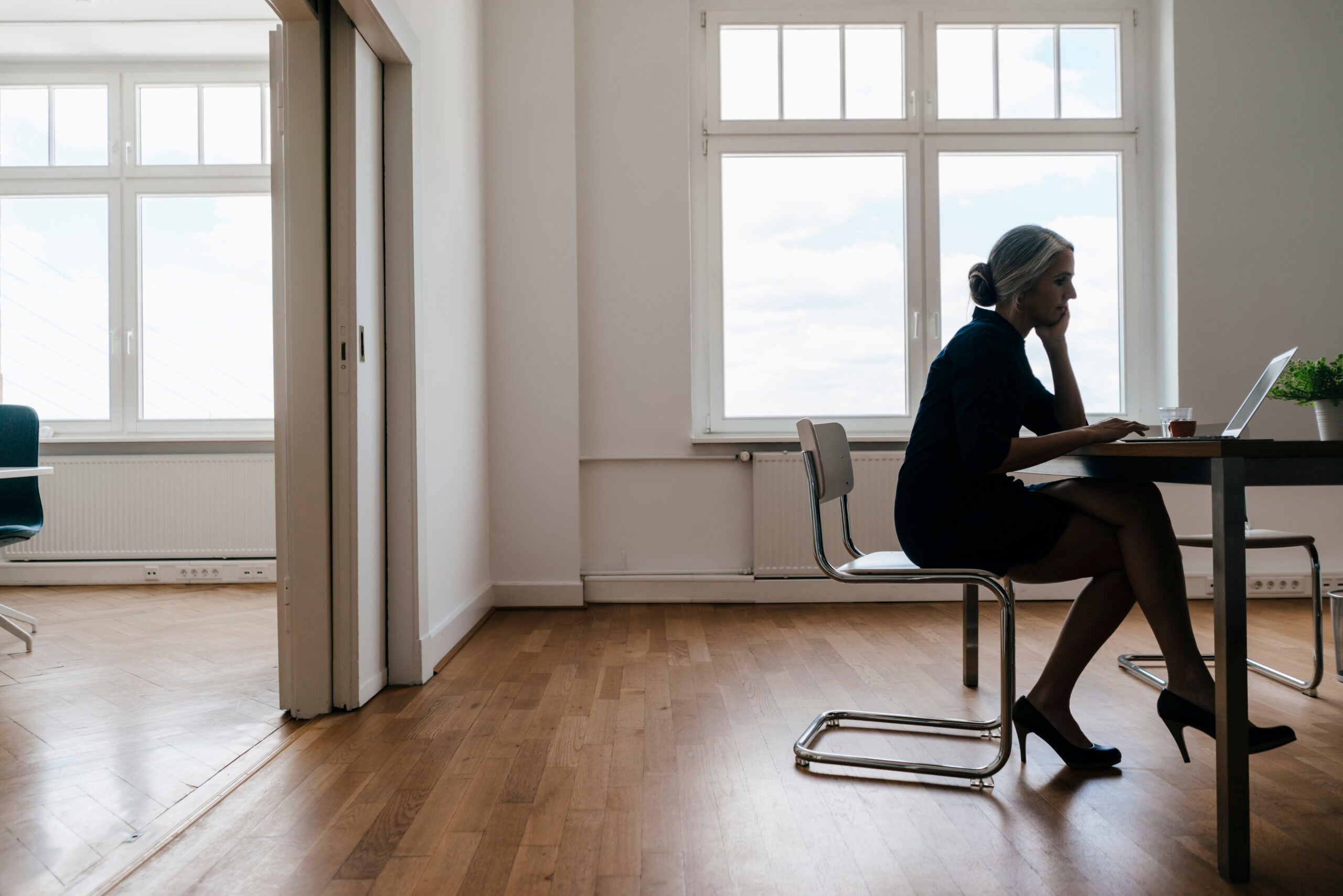 Woman sitting at a desk and computer with tight hips