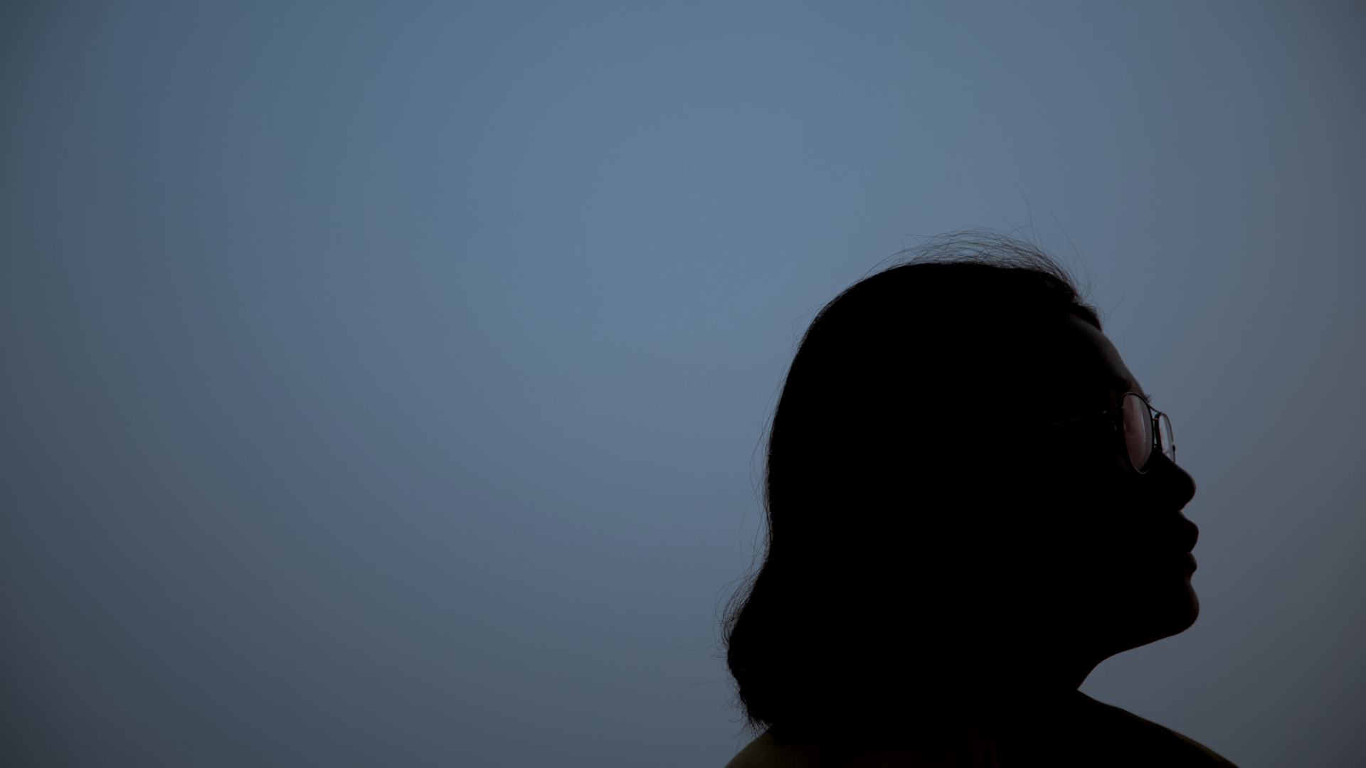 Woman standing outside at night under the new Moon in Taurus.