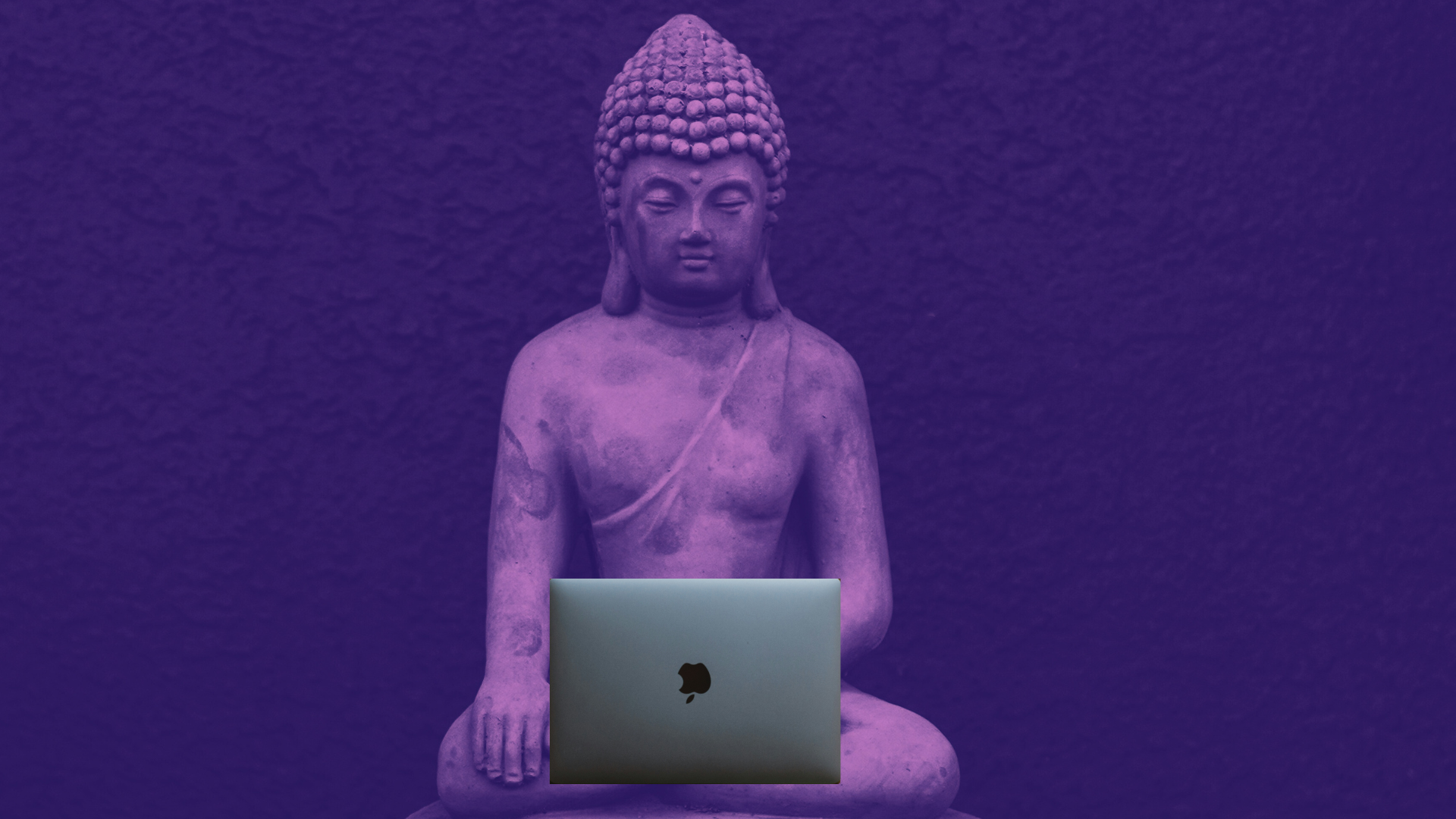 Photo illustration of a buddha sitting in meditation while holding a laptop