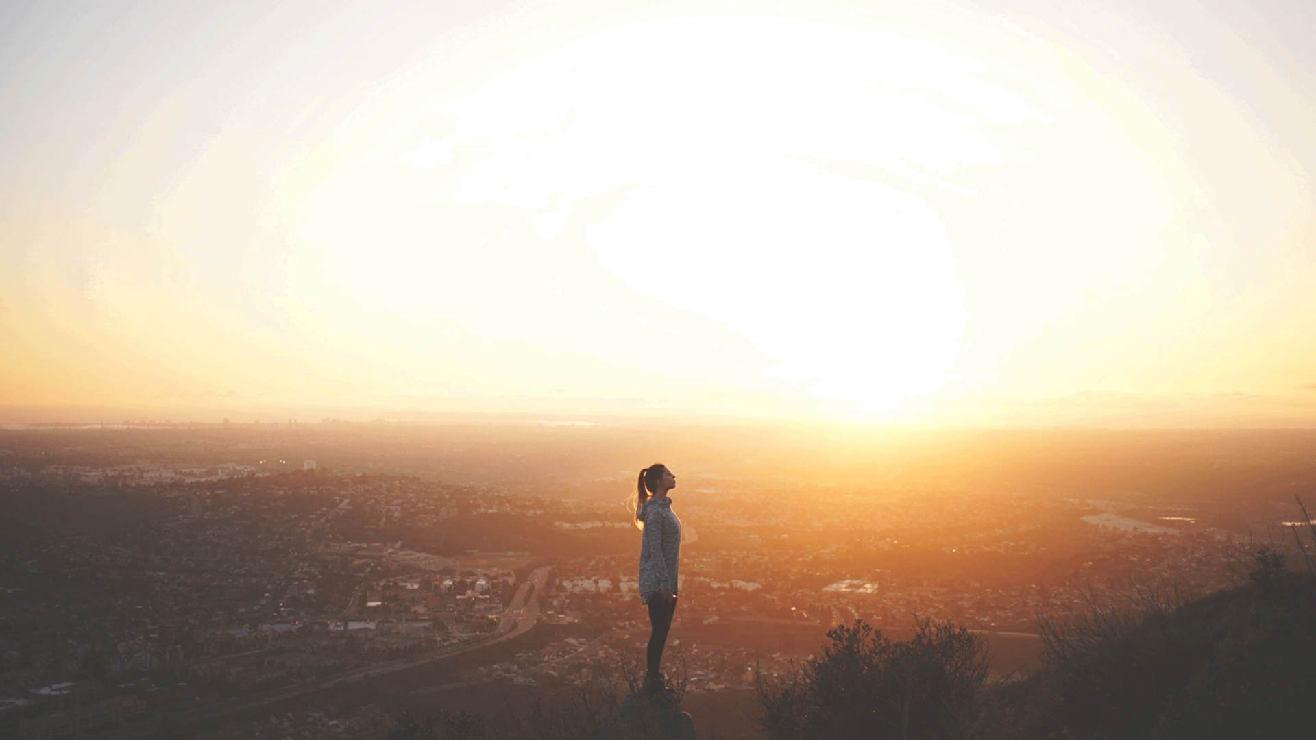 Woman standing outside at sunrise