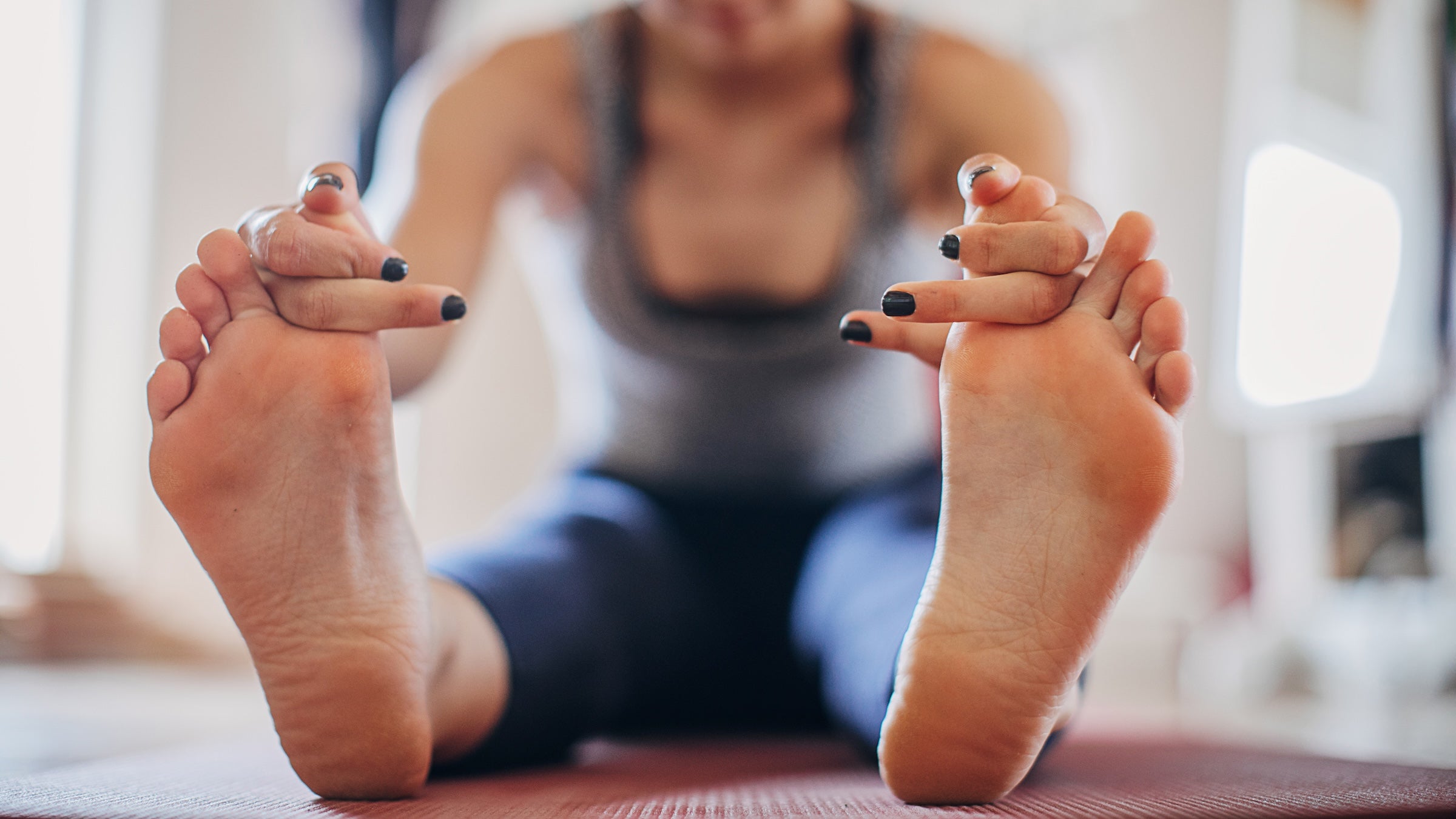 a woman practicing yogi toe lock