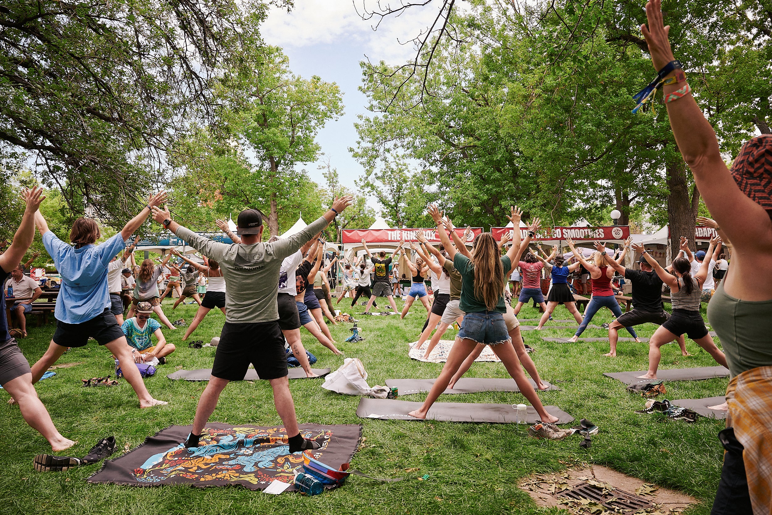 students practicing yoga at the outside festival