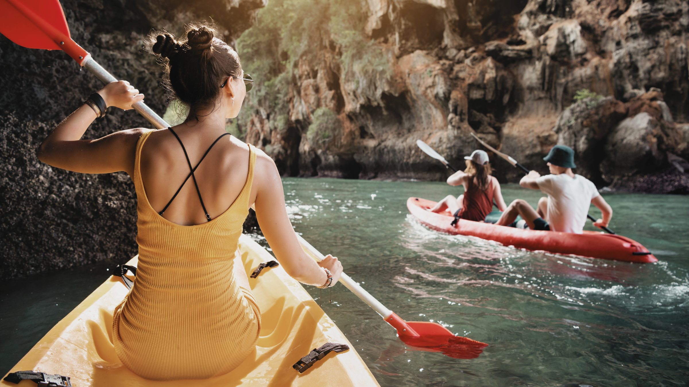 A woman kayaking, an activity featured in many yoga summer camps
