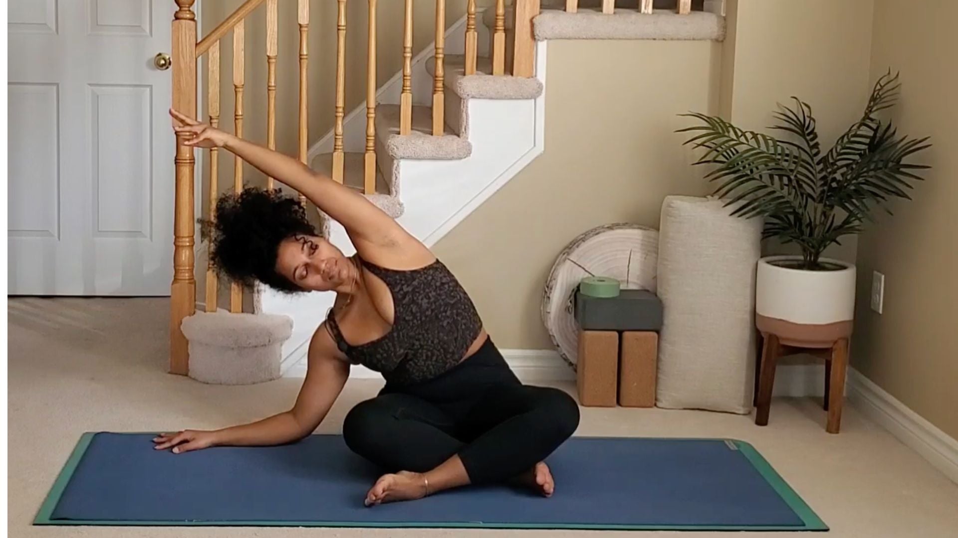 Yoga instructor doing seated side bend.