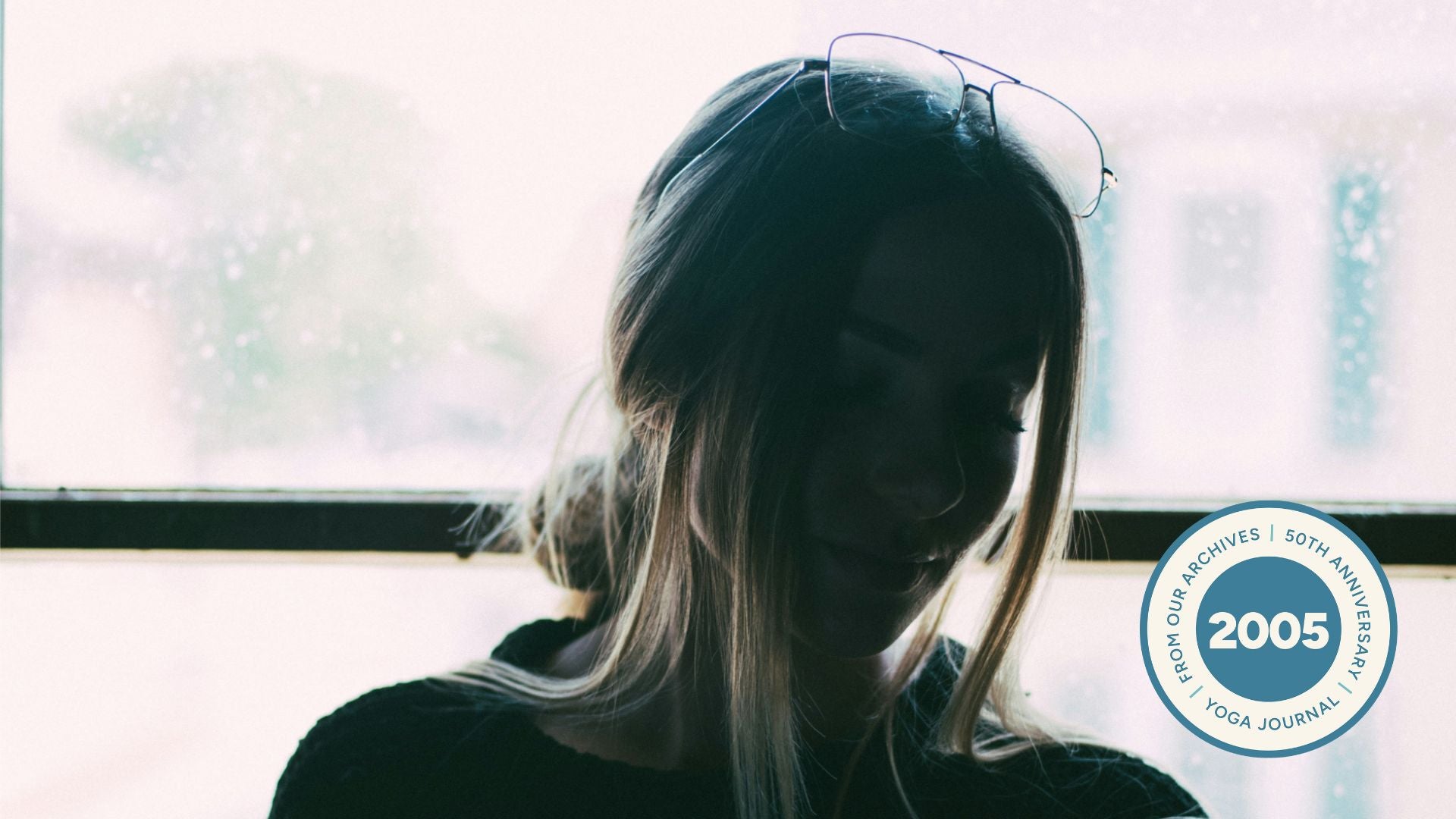 Silhouette of a young woman with her hair tied back.